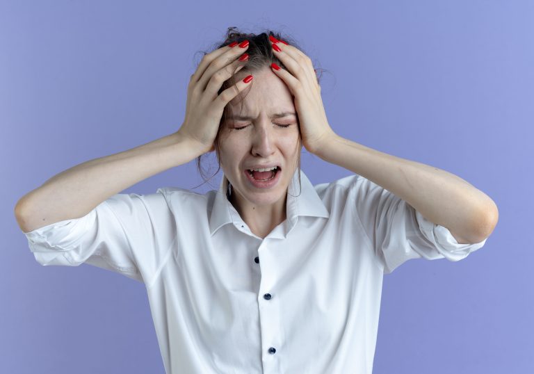 young-crying-blonde-russian-girl-holds-head-purple-with-copy-space